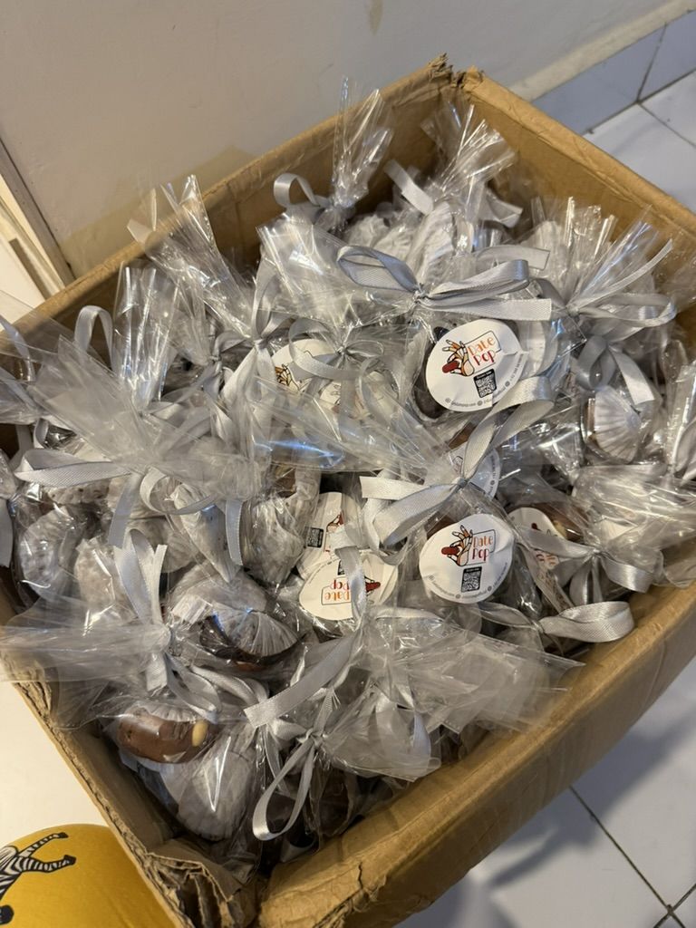 A box of clear favour bags ready for delivery