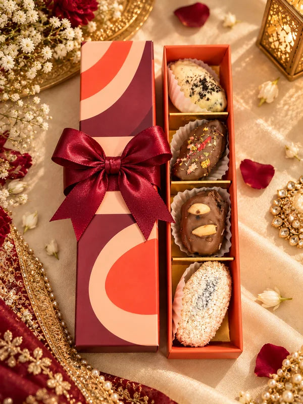 Date Pop box with a red bow and four chocolate stuffed dates