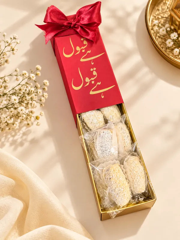 Red Qabool Hai bid box with gold calligraphy and coconut dates