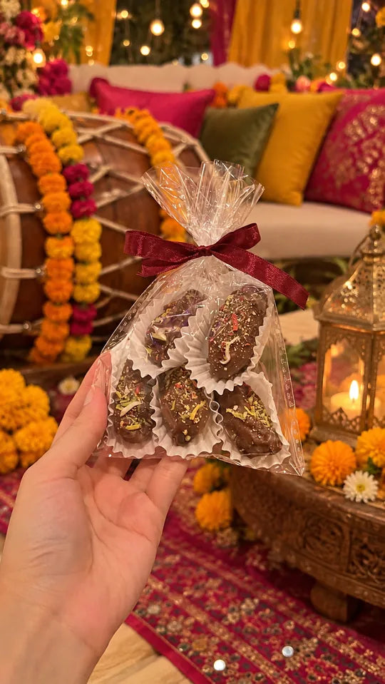 Chocolate dates in a clear favour bag with red ribbon at a mehndi