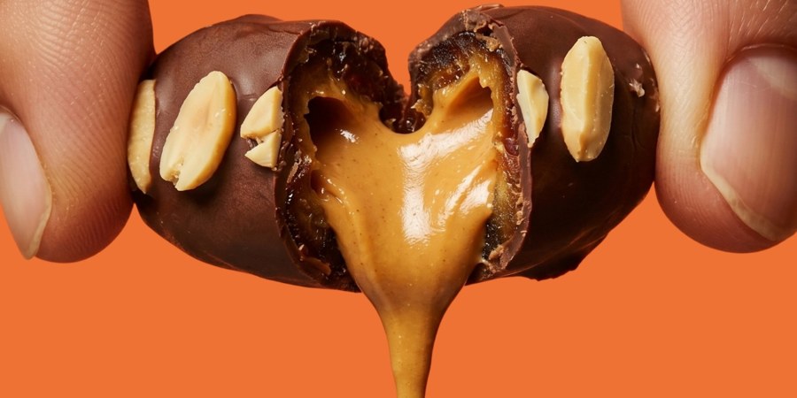 A chocolate coated date pulled open